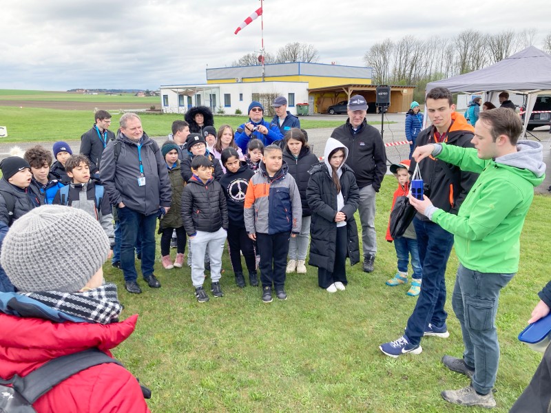 : Students explain their CanSAT to the school group