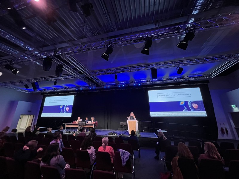 Dr. Armstrong presenting the “Rocket” project on stage at the PCST conference.: 