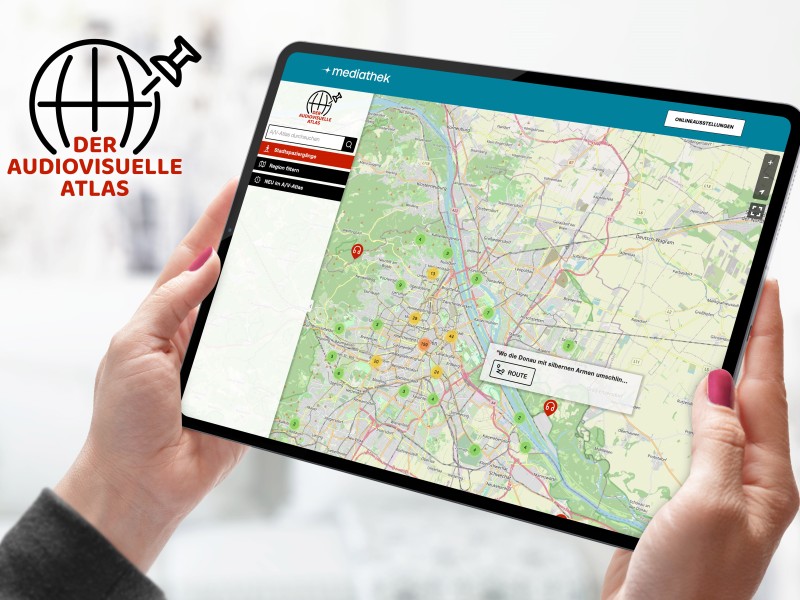 Tablet mit geöffneter Website des Audiovisuellen Atlas, auf dem eine interaktive Landkarte mit markierten Orten zu sehen ist: 