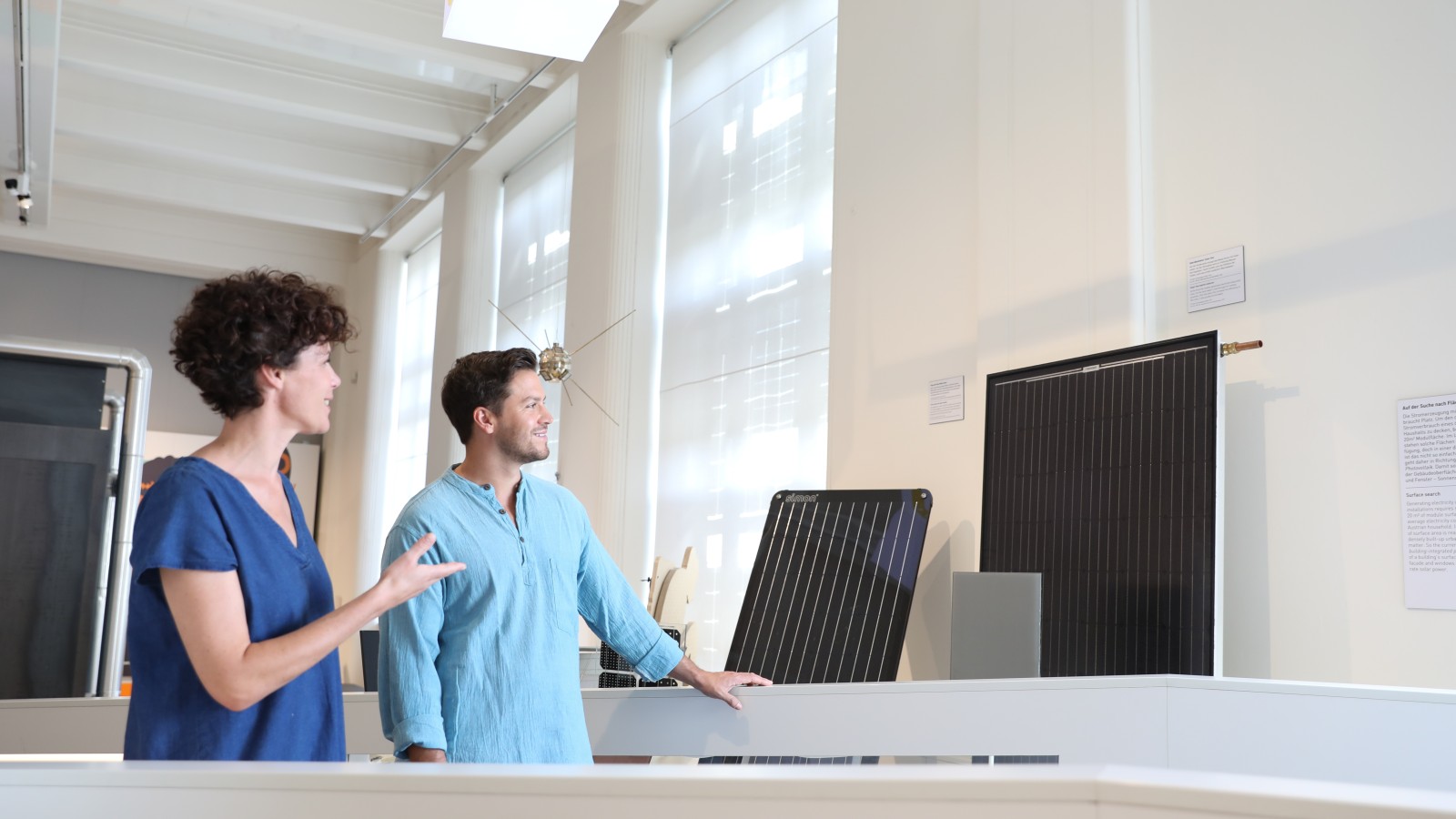A couple looks at solar panels in the "Energy" exhibition: 