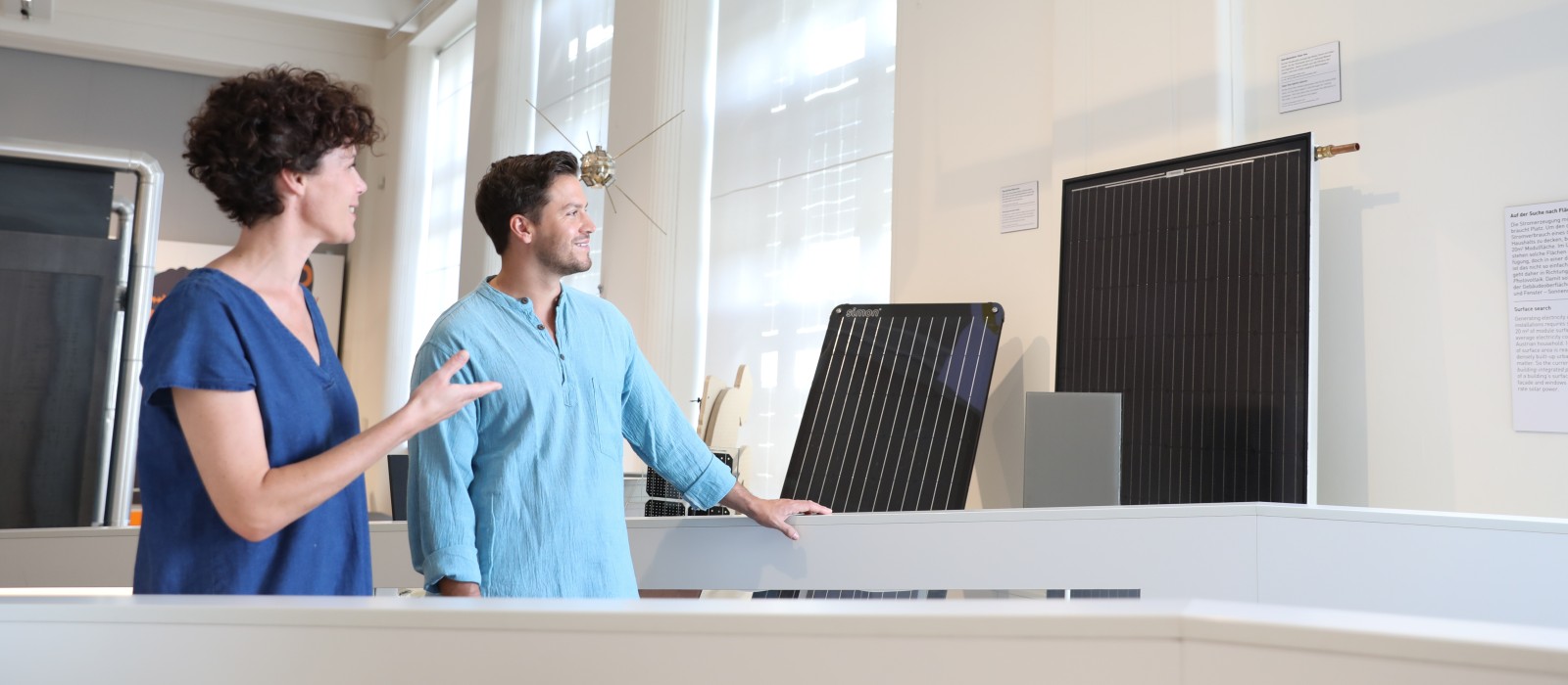 A couple looks at solar panels in the "Energy" exhibition: 